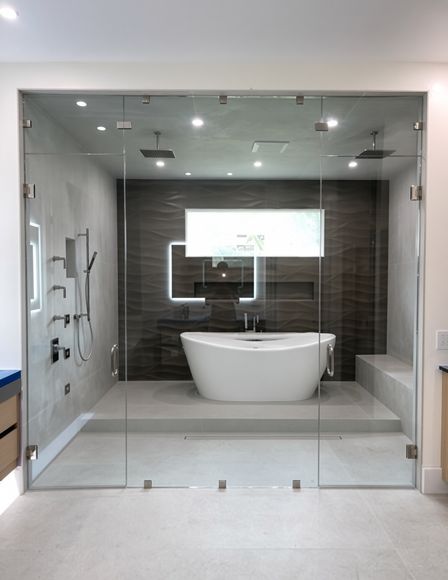 Frameless glass shower enclosure