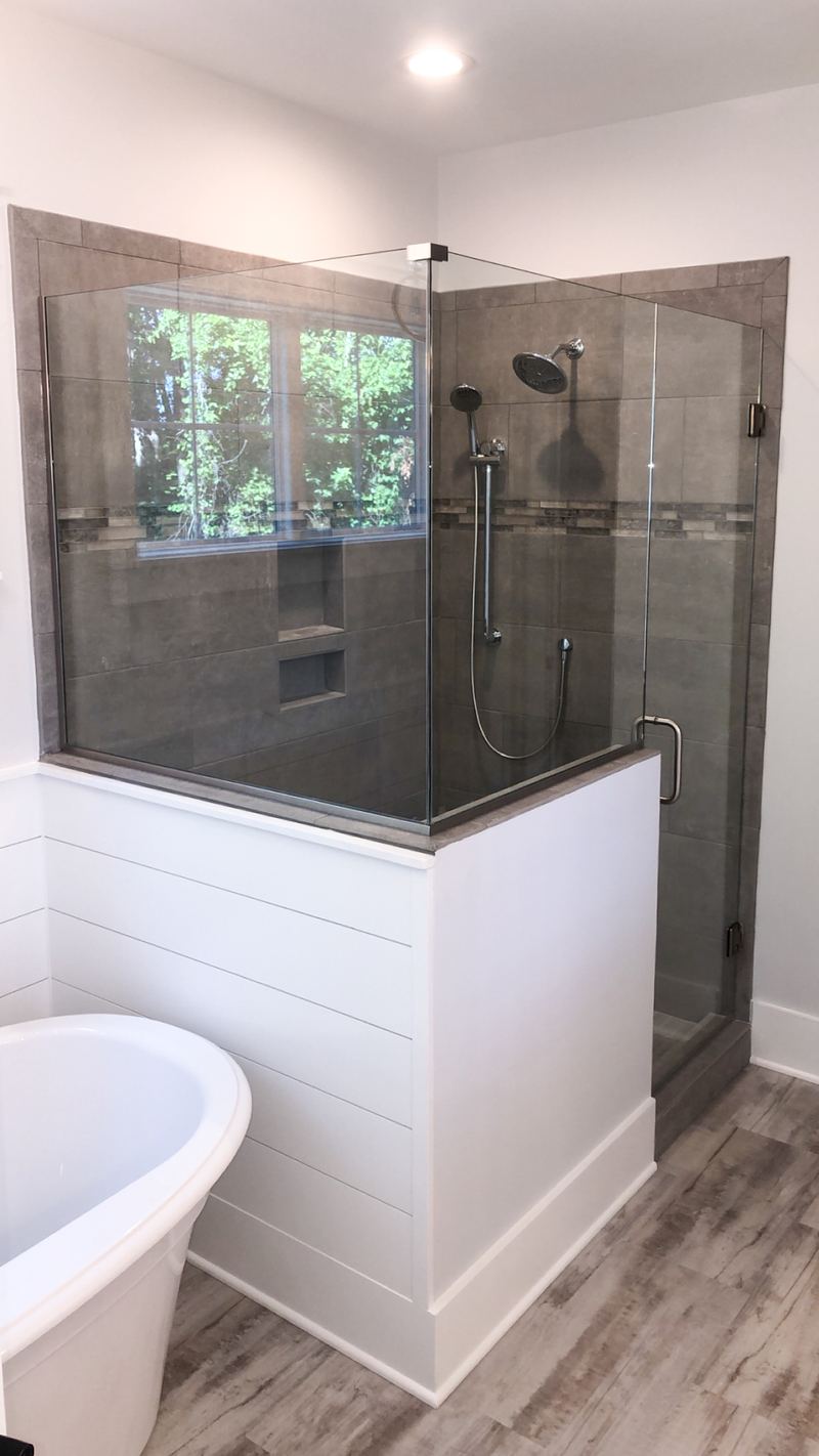 Framed Shower beside a Freestanding Tub